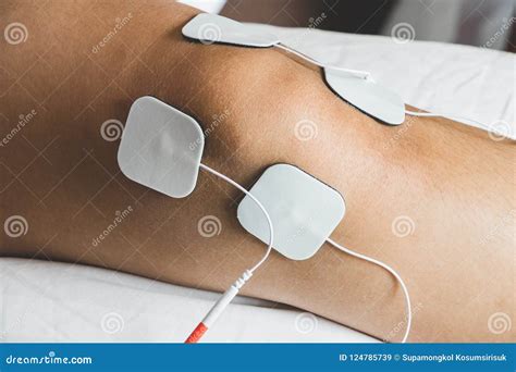 Patient Applying Electrical Stimulation Therapy on Knee Joint. T Stock ...