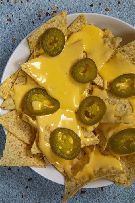This spicy homemade nacho cheese sauce recipe is easy to make and tastes just like movie theater ...