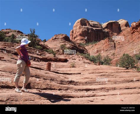 Woman tourist hikes at Cathedral Rock, a magnetic (feminine) energy ...