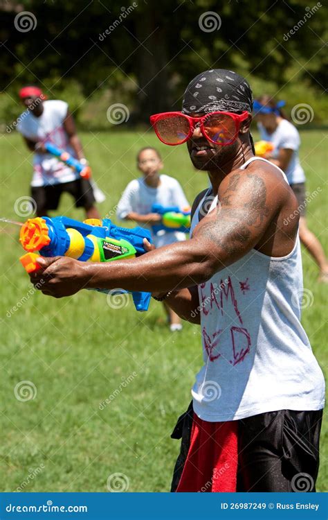 Muscular Young Man Squirts People with Water Gun Editorial Stock Image ...