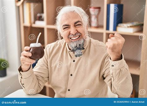 Middle Age Man with Grey Hair Drinking Mate Infusion Screaming Proud ...