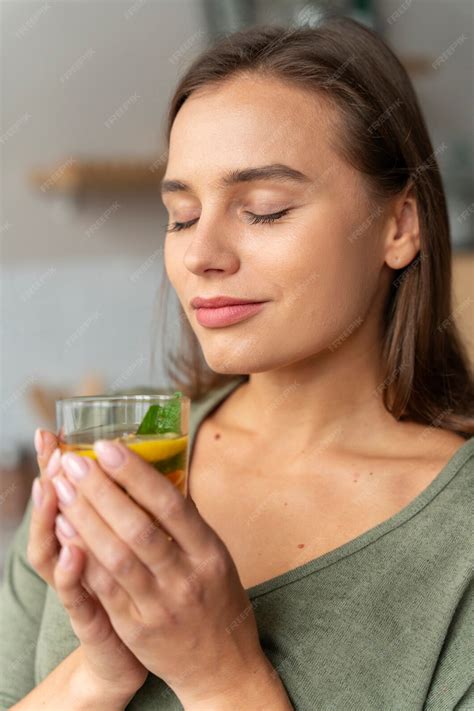 Free Photo | Person drinking kombucha at home in the kitchen