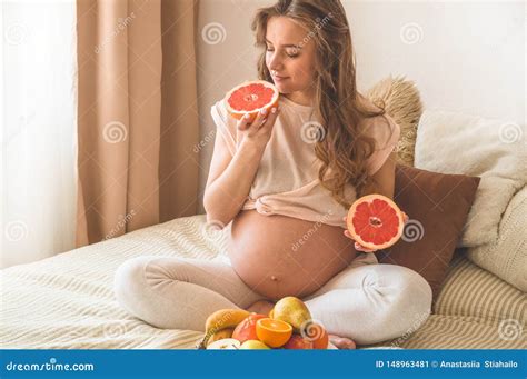 Pregnancy and Healthy Organic Nutrition. Pregnancy and Grapefruit. Pregnant Woman Enjoying Fresh ...