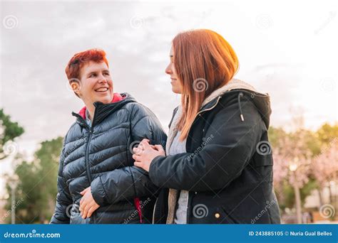 Lesbian Couple Arm in Arm Walking in a Public Park on a Spring Day ...