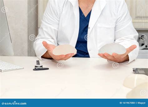 Doctor Holding Silicone Implants for Breast Augmentation, Space for Text. Plastic Surgeon Hands ...