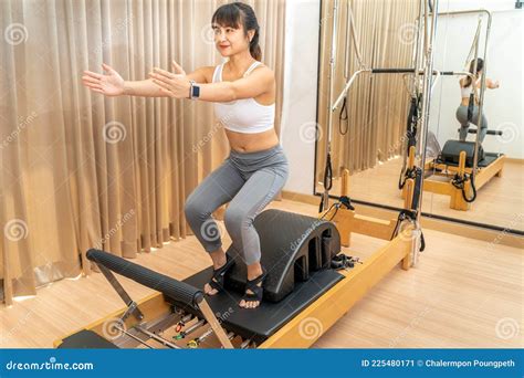 Young Asian Woman Working on Pilates Reformer Machine during Her Health ...