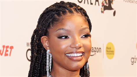 Halle Bailey flashes her bare belly and underboob in barely-there black dress as pregnancy ...