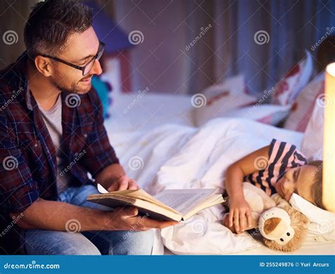 More. a Father Reading His Young Daughter a Bedtime Story. Stock Photo ...