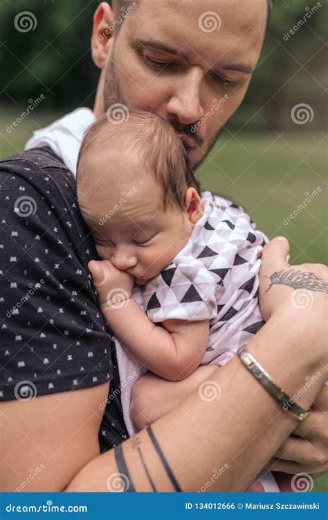 Caring Young Father Cradling His Adorable Baby Boy Outside Stock Photo ...