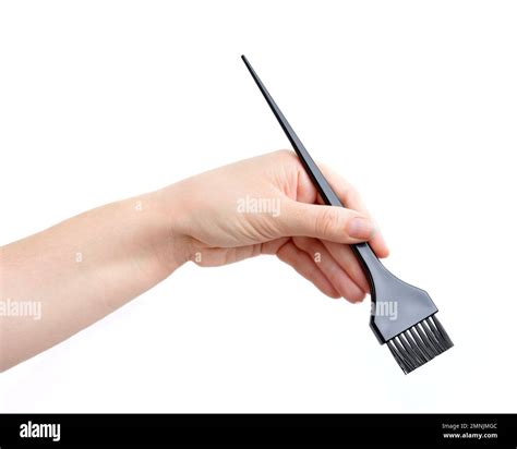 hand picking up a brush to dye the hair Stock Photo - Alamy