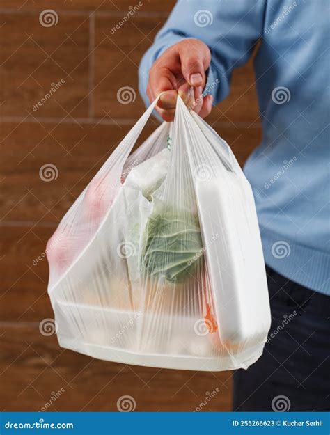 Close Up of White Transparent Plastic Bag with Food in Hand of Unknown ...