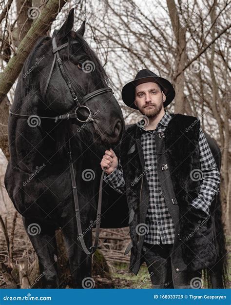 Portrait of a Guy in a Hat with a Black Horse Stock Image - Image of ...