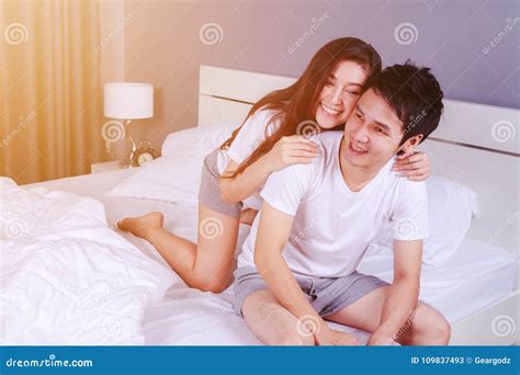 Happy Young Attractive Couple Hugging on Bed in Bedroom Stock Image ...