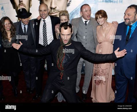 Actor Jude Law, front centre, gestures whilst from back left Susan ...