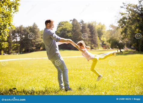 Father with Daughter Having Fun on the Grass at the Park Stock Image ...