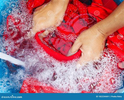 Soak Red Shirt in Laundry Detergent Water, Washing Color Clothes with ...