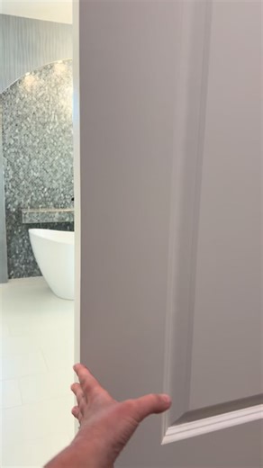 Take a step into a master bath retreat featuring heated floors, a luxury toilet, his and her shower heads and jets, beautiful accessories, and a stunning arch accent wall. #everythingyouneedinsideandout #southern #interiordesigner #interiordesign #homedesign #masterbath #masterbathroom #customcontruction | Southern Landscaping Garden & Gifts