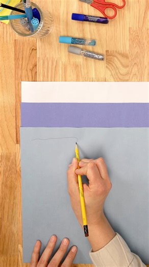 Capture the magic of winter with this stunning construction paper icicle garland! ❄️✨ Perfect for adding a touch of frosty elegance to any space. #WinterCrafts #DIYWinterDecor | Crayola