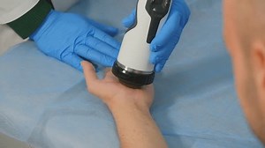 clip-1101489201-using-shockwave-therapy-equipment-doctor-performs-procedure