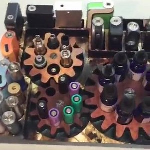 1.6K views · 42 reactions | The Gear Factor mod stand: Here you go. A new mod stand, moving gears, lots of box mods in different sizes, tube mods, rba/rda, juice bottles, batteries etc. Don't forget USA12 get you 12% discount on all mod stands and cup holders this weekend and get you into a random drawing for devices :) | JWraps | Facebook