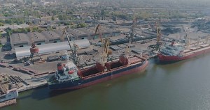 Port Crane Loads Cargo into a Dry Cargo Ship. Dry Cargo Ship at the Port Stock Video - Video of shipment, logistic: 165987093