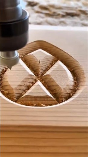 carving a beautiful geometric pattern into a light brown wood using a cnc machine