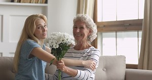 Adult Daughter Presenting Flowers Congratulating Hugging Old Mother, Portrait Stock Footage - Video of celebrating, laughing: 161551588