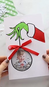 871K views · 3.6K reactions | Grinch Card ❤️ What a cute Christmas card idea! You can draw this yourself or head to my site to get the template, just search “Grinch” on my site ❤️ Then cut out the ornament bulb, add a clear plastic sheet, some adhesive foam mounts if you want to add some sequins inside or you can simply tape the photo to the back. I added a bow on top for the finished touch.  #christmascards #christmascrafts | The Best Ideas for Kids | Facebook