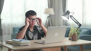 Tired Teenage Boy Feel Pain Eyestrain Holding Glasses Rubbing Dry Irritated Eyes Fatigued From Doing Home Work, Stressed Asia Teen Boy Suffer From Headache Bad Vision Sight Problem Sit At Home Table
