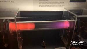 The air in this tube is being subjected to a high-voltage electric field, which frees some of the electrons that would normally cling tightly to the N₂, O₂, and other atmospheric gases inside, creating a plasma. The staff at the Exploratorium, a science museum in San Francisco, have set this one up with a magnet to perturb the electric field and a switch-operated vent hole to tweak the airflow, allowing visitors to manipulate the light show. #CENChemPics by Craig Bettenhausen/C&EN. https://cen.a