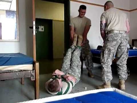 Soldier being duct taped to his bed.