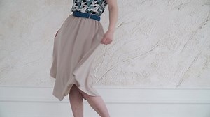 clip-1058809018-girl-twists-gray-dress-close