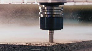 Milling machine with CNC cutting the wooden workpiece. Closeup milling cutter in work