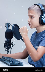 Portrait of teenage boy wearing headphones using computer keyboard and microphone. Online learning, remote education, video game, podcast concept Stock Photo - Alamy