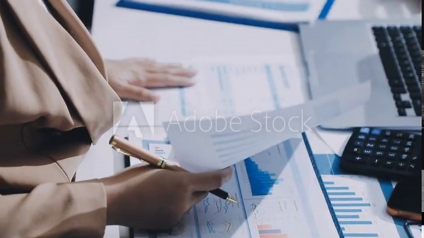 Doing finance, budgeting and tax calculation. Close up woman hand using calculator to calculate home finance, accounting with laptop computer on table, budget management, monthly expenses.