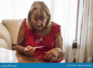 Older Woman Measuring Her Temperature With The Thermometer Stock Image