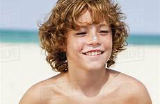 boy beach spain sitting stock smiling dissolve westend61