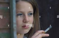 smoking girl cigarette teenage behind shed stock alamy