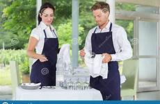 male waiters female restaurant gourmet setting tables