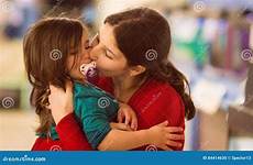 kissing girl young sister her stock cheek holding portrait