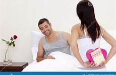 wife valentine giving husband present her stock bed
