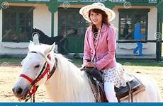 asian horse girl white riding stock
