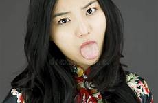 tongue asian woman poking young towards colored camera background stock her sticking