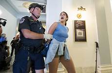 arrested protesters police arizona officer her away capitol office led handcuffed protest arrest flake after care health rally pinalcentral during