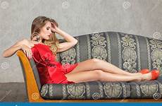 sofa sitting woman couch young red dress beautiful vintage luxurious stock