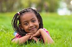 girl young smiling african little girls outdoor cute portrait stock down long child hair pe outside hairstyles kids grass school
