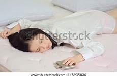 sleeping drunk whiskey flask hip bed hand woman young shutterstock stock search