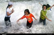 clothed water fully children playing vietnamese sea splashing tourist stock alamy waves