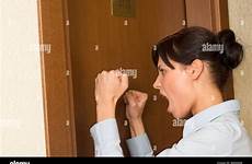 door knocking angrily hotel businesswoman headshot alamy against young