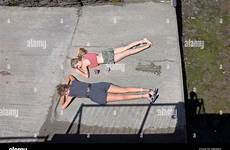 sunbathing girls alamy cornwall stock padstow two